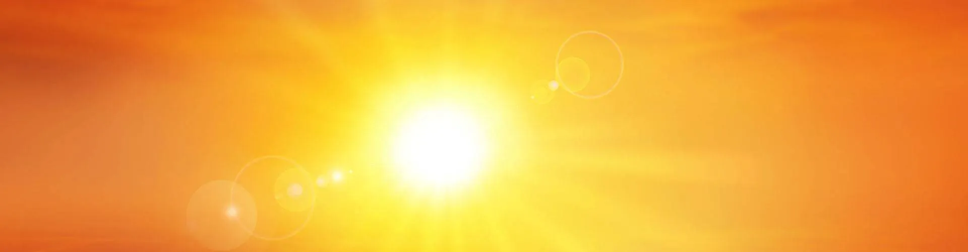 Bright summer sun blazing in an orange sky
