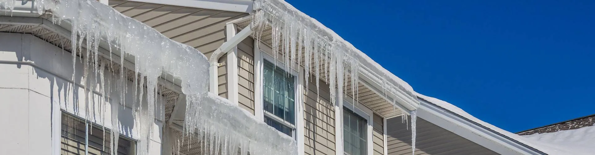 Icicles and ice build-up hanging from a home’s eavestroughs