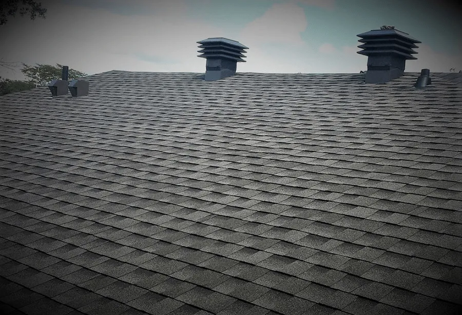 Dark shingle roof with two roof vents