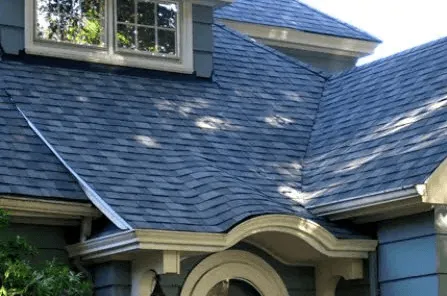 Blue-grey shingle roof above a bay window